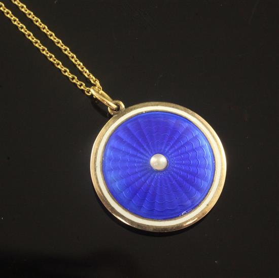 An Edwardian gold, blue guilloche enamel and split pearl circular pendant locket, on a 15ct gold fine link chain, pendant 21mm.